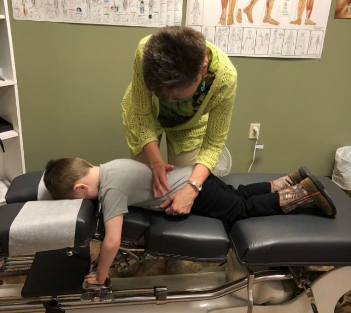 A young boy at the chiropractor office at A Touch of Health Chiropractic